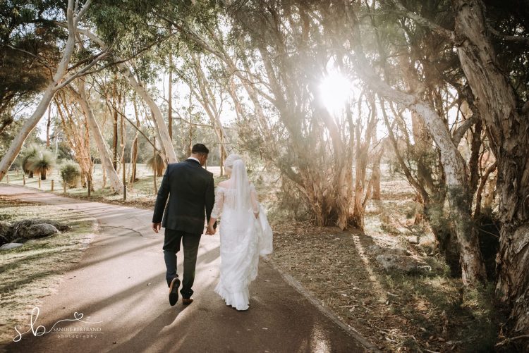 sunset walking bride and groom the vines