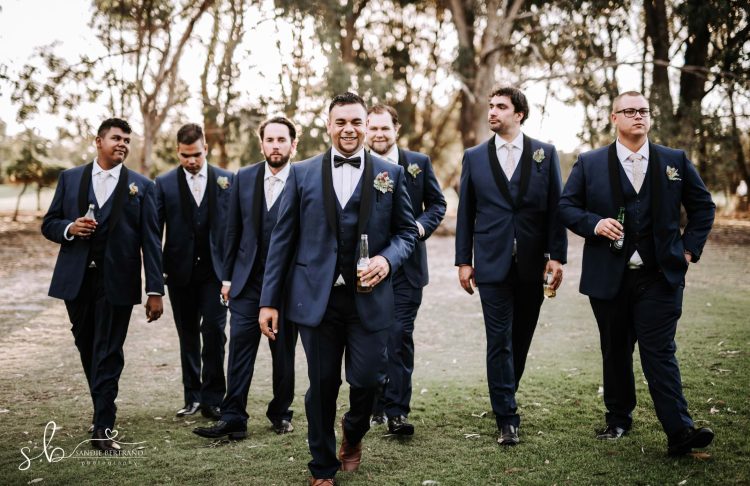 the vines groomsmen walking