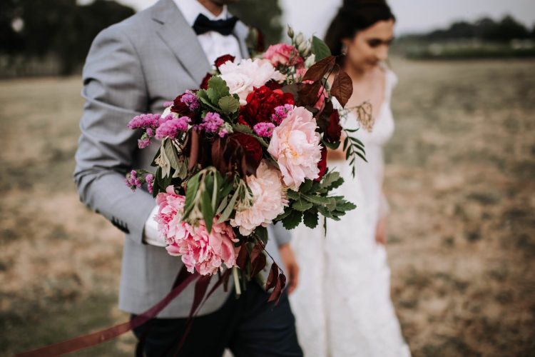 sandalford wedding bride and groom walking with bouquet